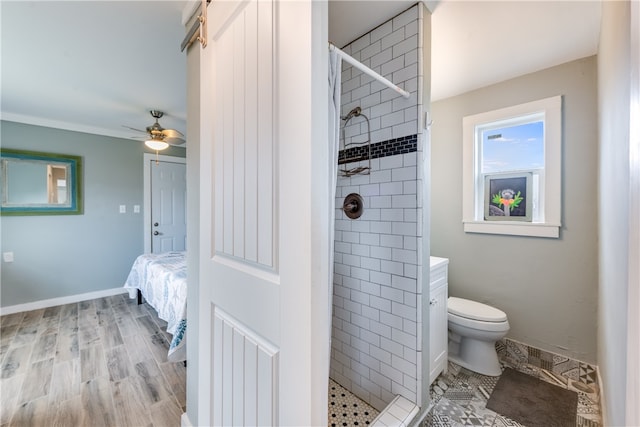 bathroom featuring wood-type flooring, vanity, toilet, and a tile shower