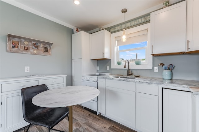 kitchen featuring white cabinets, hardwood / wood-style floors, sink, pendant lighting, and white electric range