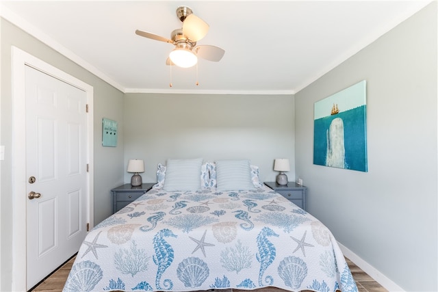 bedroom featuring ornamental molding, hardwood / wood-style floors, and ceiling fan