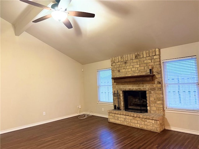 unfurnished living room with a fireplace, a healthy amount of sunlight, dark hardwood / wood-style floors, and vaulted ceiling with beams