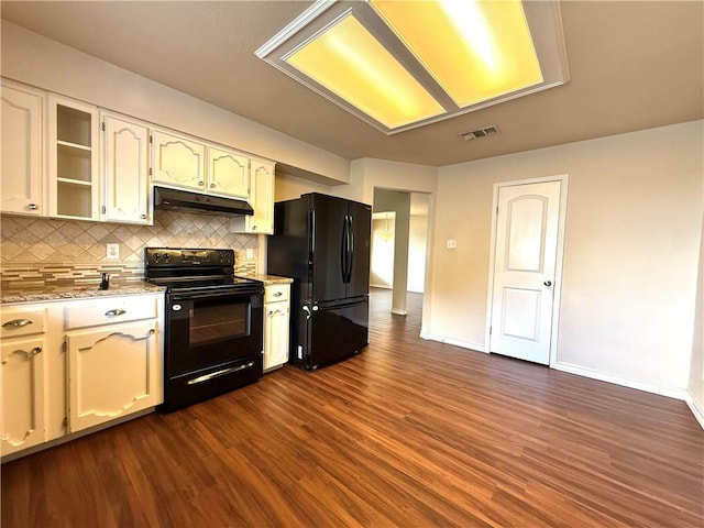 3325 Hampton St, Corpus Christi, TX 78414 - kitchen featuring black appliances, under cabinet range hood, dark wood-type flooring, backsplash, and light stone countertops