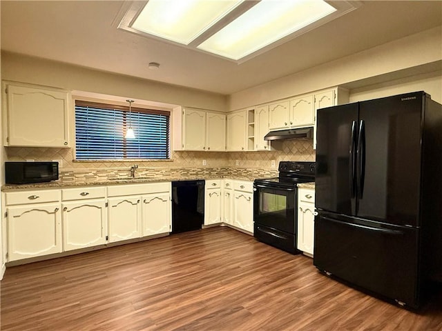 kitchen with dark wood-type flooring, sink, white cabinetry, hanging light fixtures, and black appliances