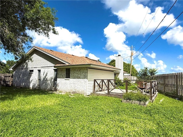 3325 Hampton St, Corpus Christi, TX 78414 - rear view of property featuring a fenced backyard, a chimney, and a garage