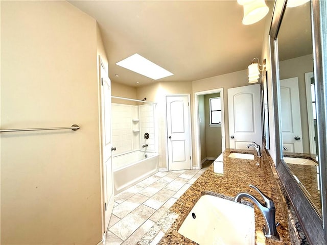 3325 Hampton St, Corpus Christi, TX 78414 - bathroom with a skylight, double vanity, washtub / shower combination, and stone finish floors