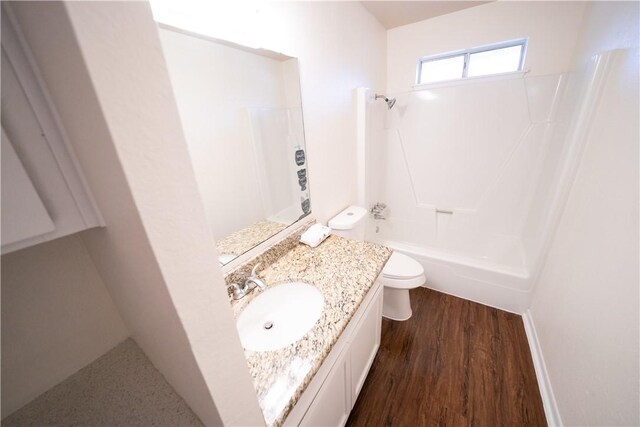 full bathroom with vanity, toilet, wood-type flooring, and washtub / shower combination