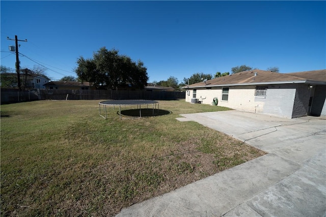 view of yard with a patio and a trampoline