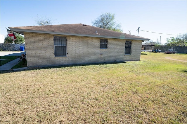 view of side of home with a yard