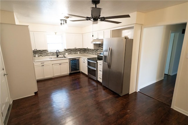 kitchen featuring appliances with stainless steel finishes, tasteful backsplash, ceiling fan, sink, and white cabinetry