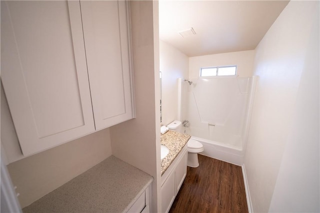 full bathroom with hardwood / wood-style floors, vanity, toilet, and bathing tub / shower combination