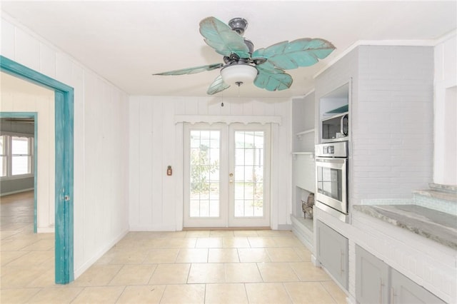 doorway featuring crown molding, a healthy amount of sunlight, ceiling fan, and french doors