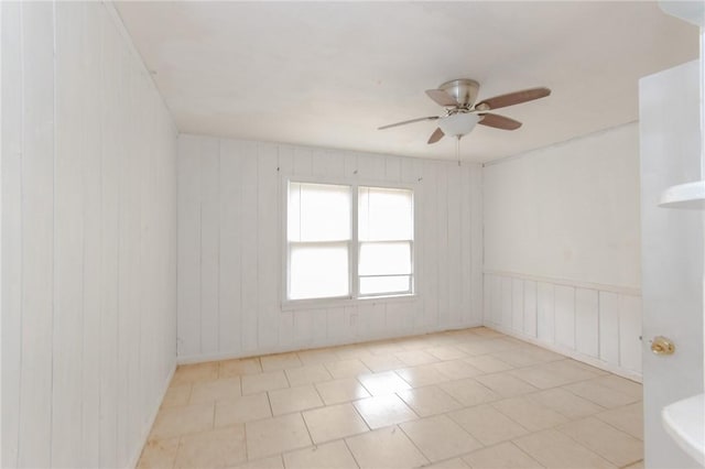 spare room with light tile patterned flooring and ceiling fan