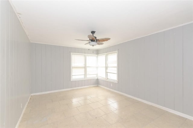 empty room with ornamental molding and ceiling fan