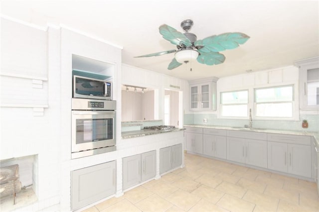 kitchen featuring sink, gray cabinets, ceiling fan, and appliances with stainless steel finishes