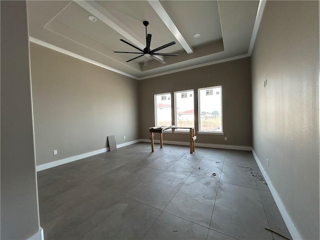 unfurnished room featuring ceiling fan, a tray ceiling, crown molding, and concrete flooring