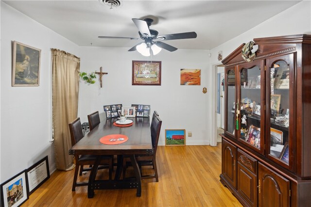 dining space with light wood-type flooring and ceiling fan