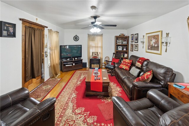 living room featuring light wood-type flooring and ceiling fan