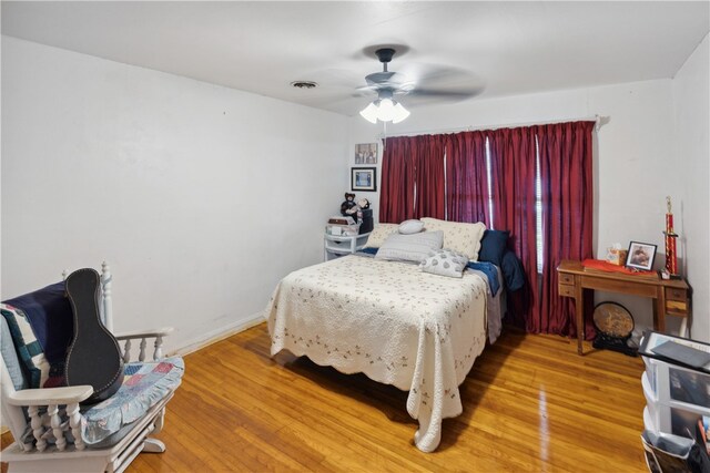 bedroom featuring wood-type flooring and ceiling fan