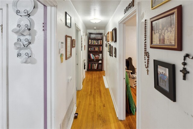 corridor with light hardwood / wood-style floors