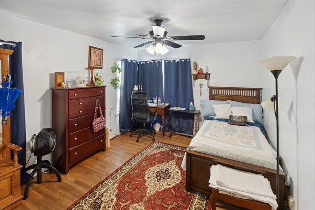 bedroom with ceiling fan and light hardwood / wood-style flooring