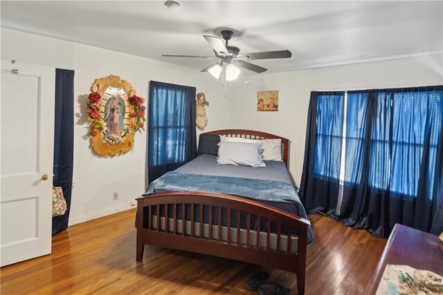 bedroom with hardwood / wood-style flooring and ceiling fan