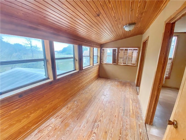 unfurnished sunroom featuring vaulted ceiling and wooden ceiling