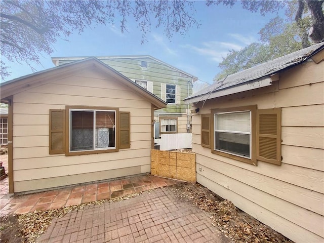 view of side of home with a patio area