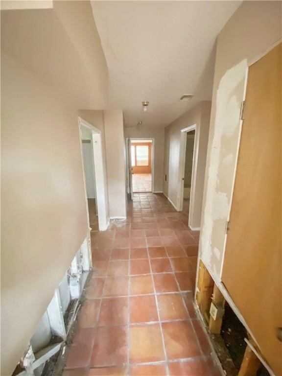 hall featuring light tile patterned floors