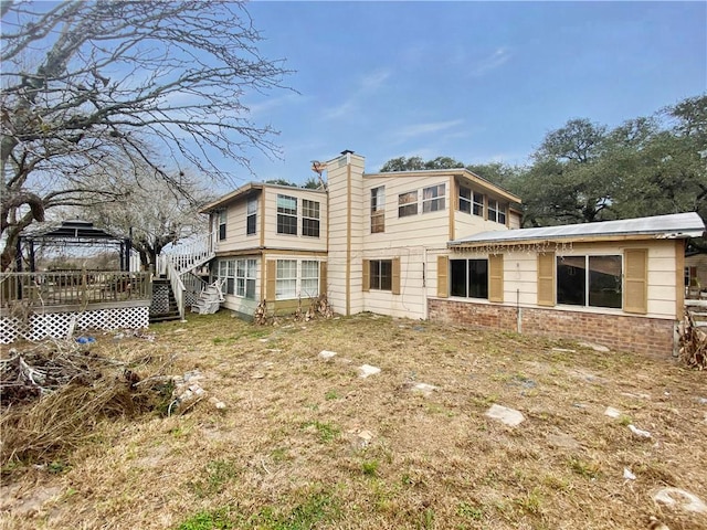 back of house with a wooden deck and a gazebo