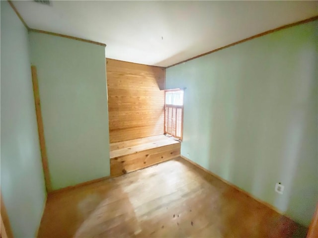 unfurnished bedroom featuring wood walls