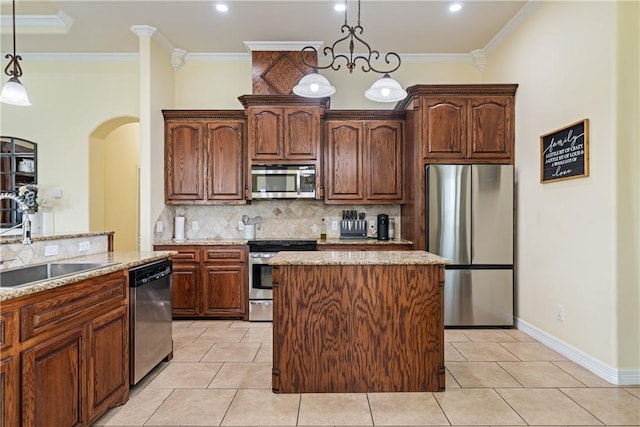 11330 Brendel, Corpus Christi, TX 78410 - kitchen with appliances with stainless steel finishes, light stone counters, decorative backsplash, crown molding, and arched walkways
