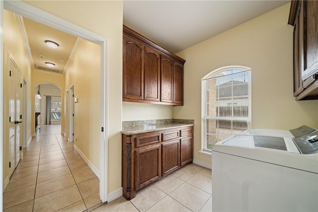 11330 Brendel, Corpus Christi, TX 78410 - laundry room with washing machine and dryer, arched walkways, cabinet space, light tile patterned floors, and ornamental molding
