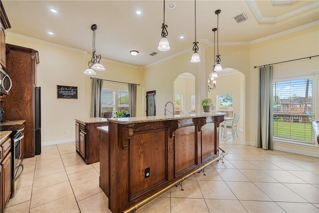 11330 Brendel, Corpus Christi, TX 78410 - kitchen with arched walkways, a kitchen island with sink, appliances with stainless steel finishes, light tile patterned floors, and crown molding