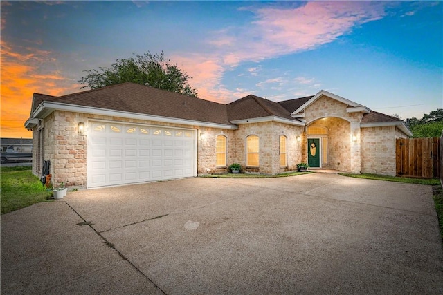 11330 Brendel, Corpus Christi, TX 78410 - view of front of home with concrete driveway, an attached garage, roof with shingles, and stone siding