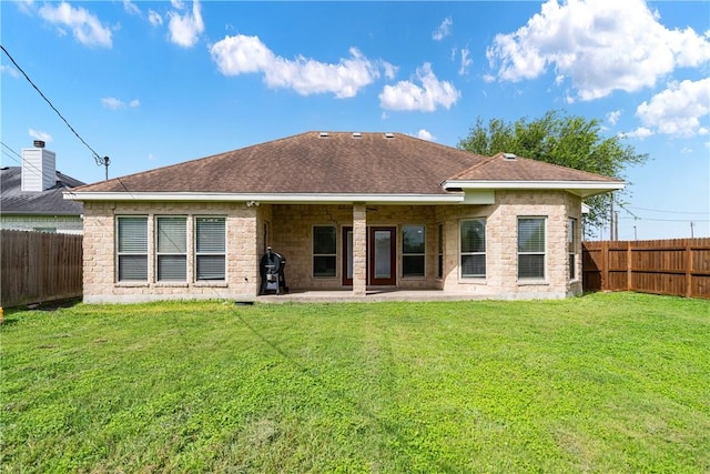 11330 Brendel, Corpus Christi, TX 78410 - rear view of house featuring a fenced backyard, a patio area, a shingled roof, and stone siding