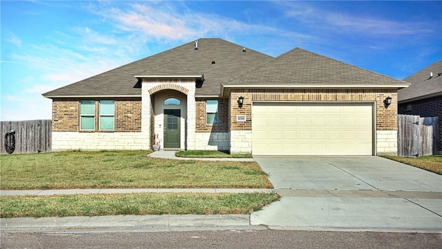 view of front of house featuring a garage and a front yard