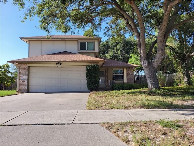 2213 Alazan Dr, Corpus Christi, TX 78418 - view of front of house featuring driveway, fence, an attached garage, and brick siding