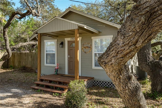 view of front of house featuring fence and central air condition unit