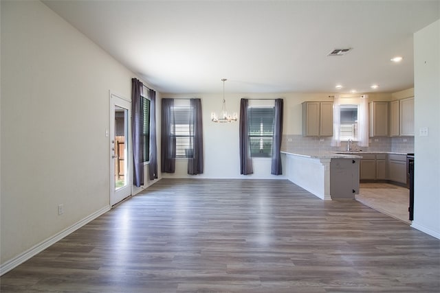 2063 Wind Chime Way, New Braunfels, TX 78130 - kitchen featuring wood finished floors, a sink, decorative backsplash, a notable chandelier, and visible vents