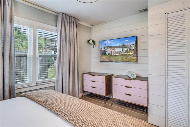 bedroom with wood walls