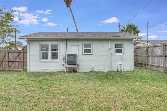 back of property with a yard and cooling unit