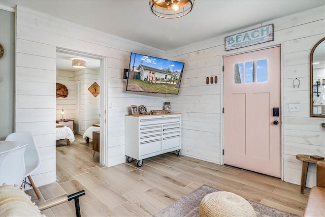 foyer entrance featuring wood walls