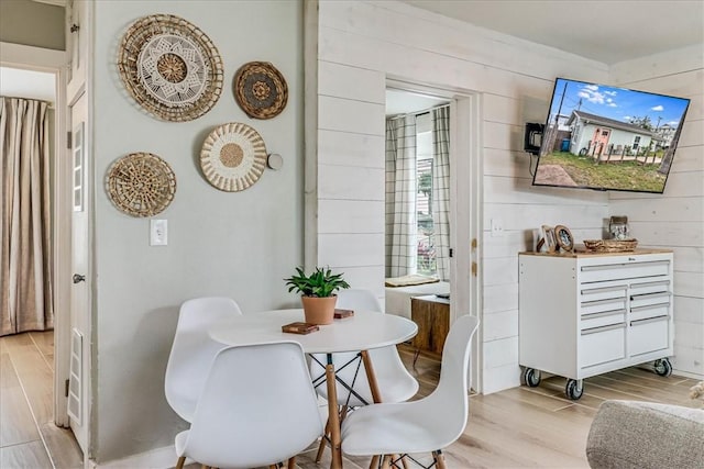 dining area with wood walls