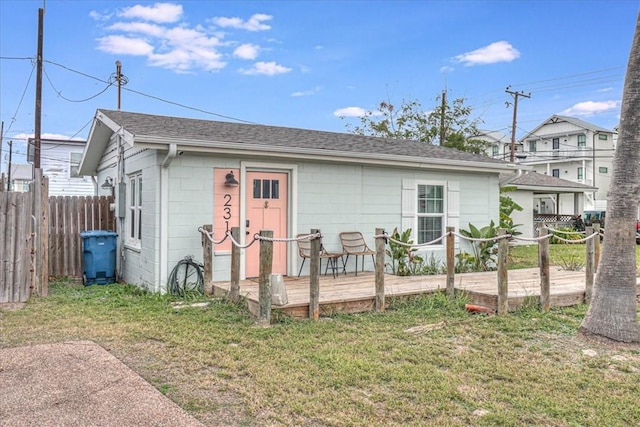 view of front facade featuring a front yard and a deck