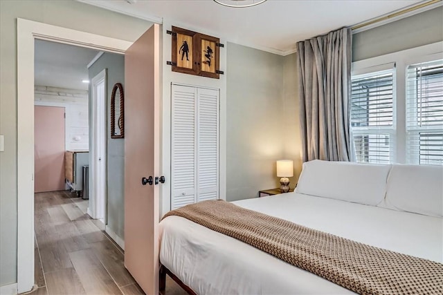 bedroom with hardwood / wood-style floors and a closet