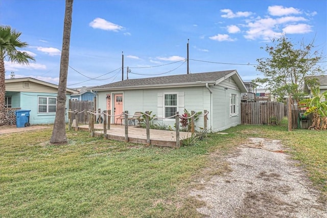 view of front of home with a front yard and a deck