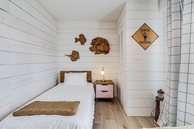 bedroom with wood walls