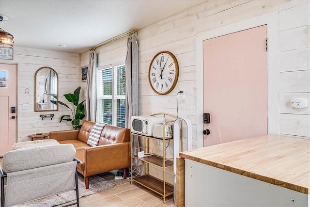 living area featuring wood walls