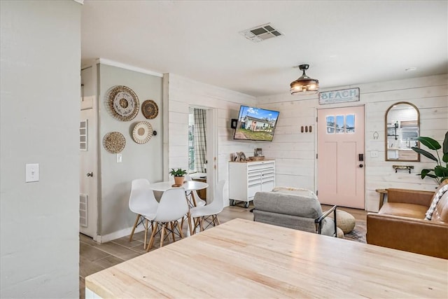 dining room featuring wooden walls