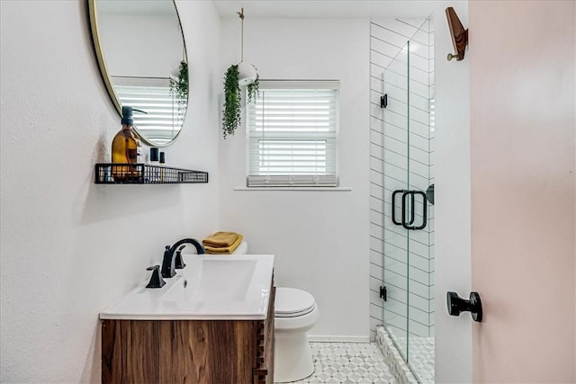 bathroom featuring vanity, tile patterned flooring, a shower with shower door, and toilet