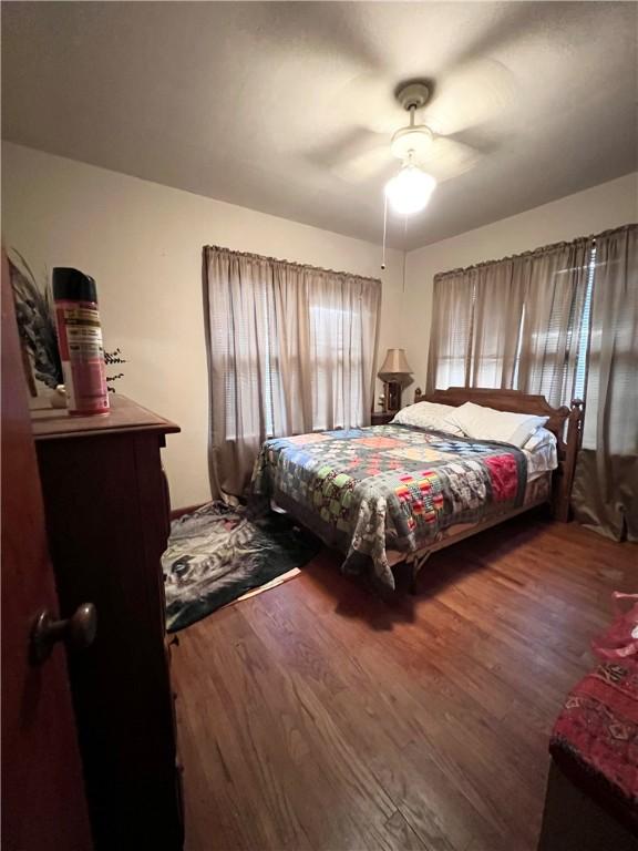 bedroom featuring a ceiling fan and wood finished floors